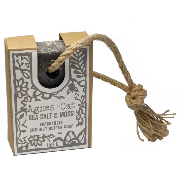 A dark gray textured soap bar of agnes+cat sea salt and moss fragranced coconut butter soap in a rustic floral box
