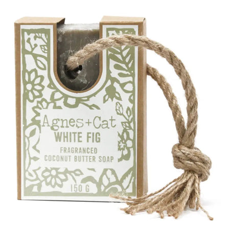 A sage green rectangular bar of agnes plus cat white fig fragranced coconut butter soap in a floral box with jute rope