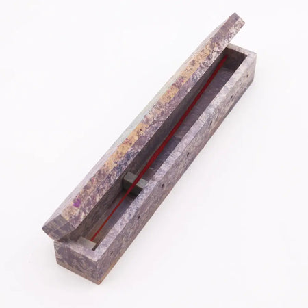 A rectangular soapstone incense box with a marbled purple and beige surface for holding soapstone incense