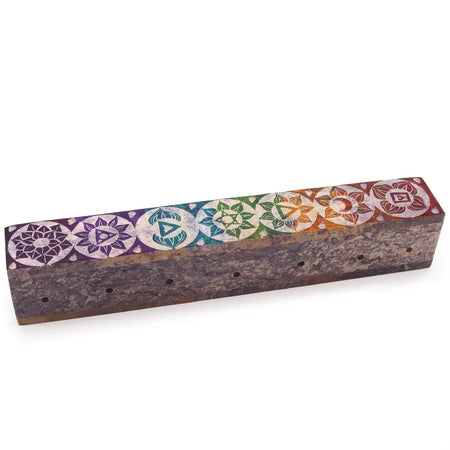 A rectangular soapstone incense box with a dark brown base and colorful chakra designs on top