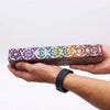 A rectangular wooden soapstone incense box with seven colorful chakra symbols on its polished surface