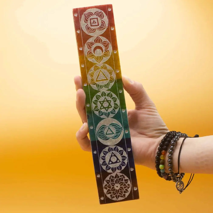 Soapstone incense holder with rainbow-colored chakra meditation mat featuring seven distinct symbolic designs