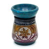 A hand carved multicolored soapstone oil burner with a teal bowl and intricate floral design for oil use