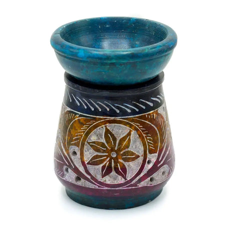A hand carved multicolored soapstone oil burner with a teal bowl and intricate floral design for oil use