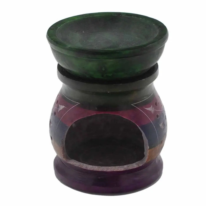 A hand-carved multicolored soapstone oil burner with dark green top and geometric flower of life patterns