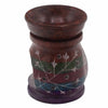 Soapstone oil burner with hand carved floral etchings in white on green red and blue bands with dark brown oil bowl