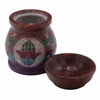 Hand carved soapstone oil burner with circular silver inlay featuring hamsa hand and birds, green and teal bands