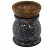 Soapstone oil burner with black floral carvings and marbled amber bowl for oil diffusion