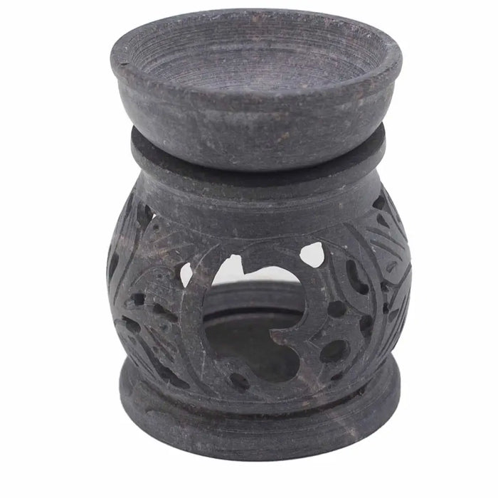 Dark gray soapstone oil burner with carved floral patterns and smooth rounded bowl for oil use featuring om symbol