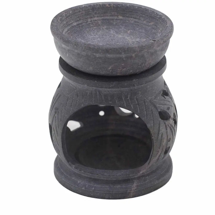 Dark gray soapstone oil burner with carved leaf patterns and a smooth rounded bowl featuring the om symbol