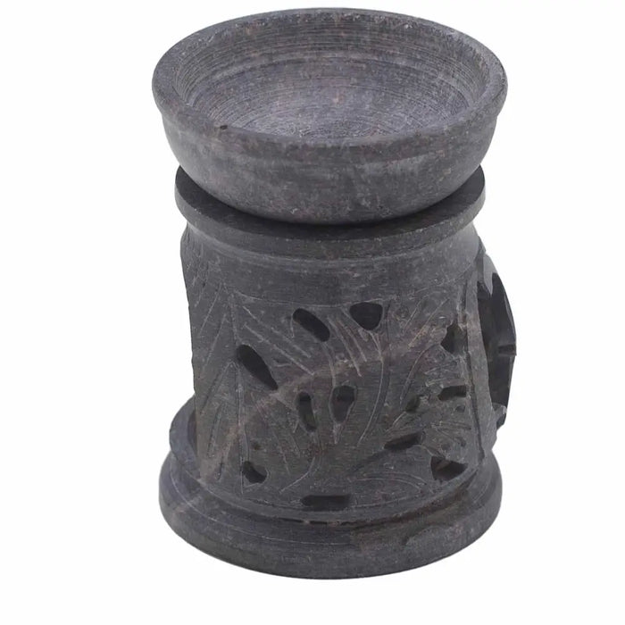 Dark gray soapstone oil burner with carved leaf patterns and om symbol cut-out ventilation holes