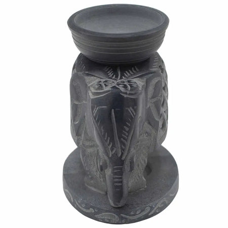 Dark gray soapstone oil burner shaped like a standing elephant with intricate carvings and a smooth rounded top