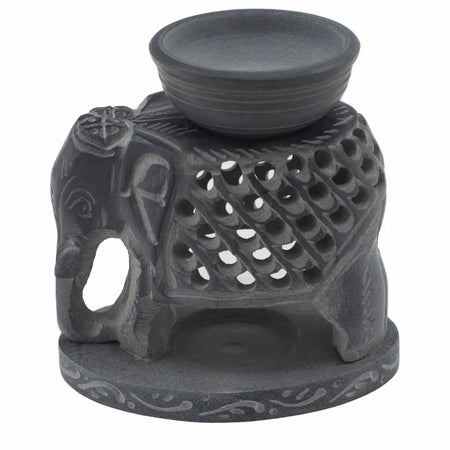 Dark gray soapstone oil burner shaped like a standing elephant with carved patterns and perforated back for ventilation