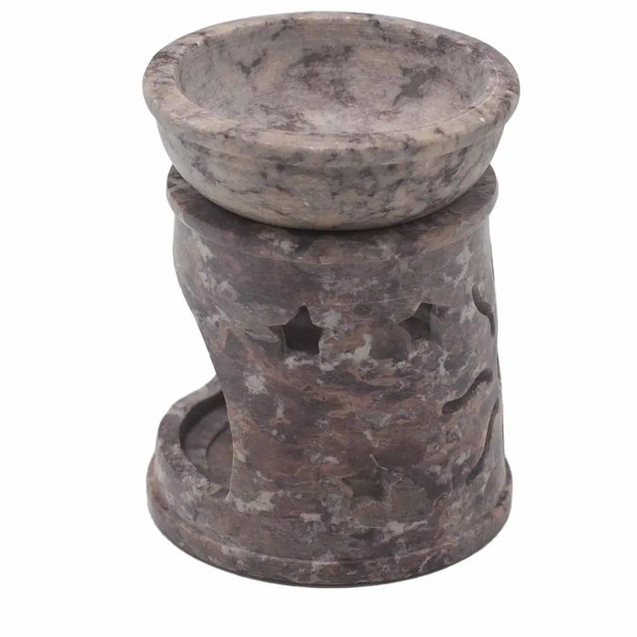 A rustic gray soapstone oil burner with a bowl top and star cutout details on its cylindrical base