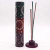 A tall soapstone tower incense holder with intricate maroon teal and silver sun and moon designs