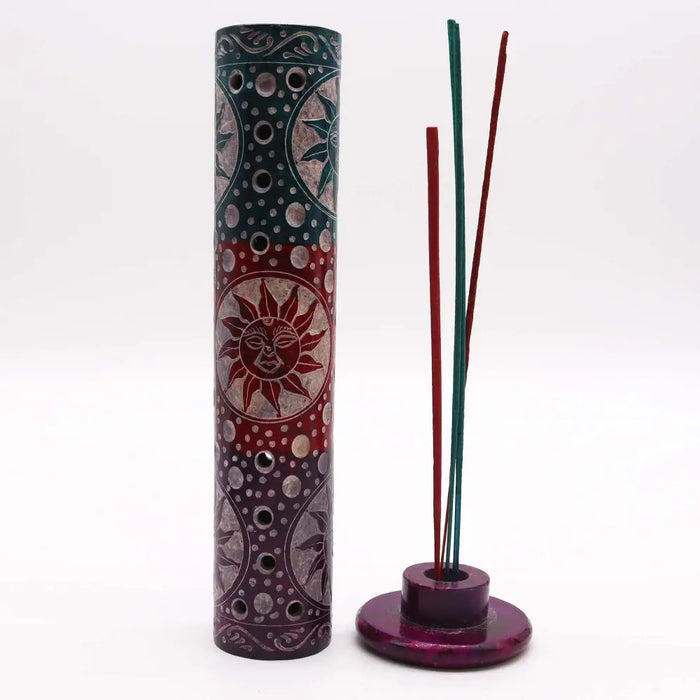 A tall soapstone tower incense holder with intricate maroon teal and silver sun and moon designs