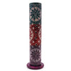 A dark green and red soapstone tower incense holder with carved sun faces and circular designs