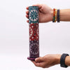 Hand carved soapstone tower incense holder with cylindrical shape and sun motifs in teal red and purple colors
