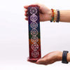 Rainbow-colored soapstone tower incense holder with vertical stripes and seven white chakra symbols etched on it