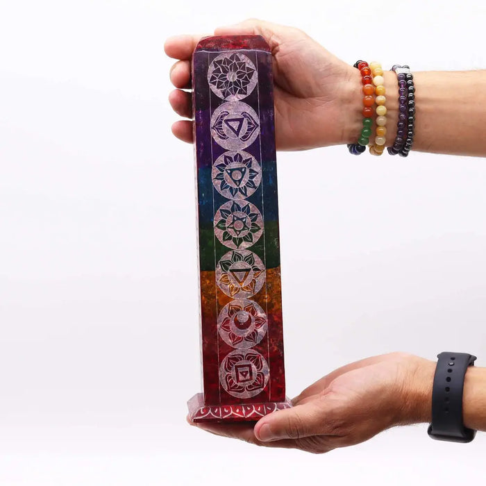 Rainbow-colored soapstone tower incense holder with vertical stripes and seven white chakra symbols etched on it