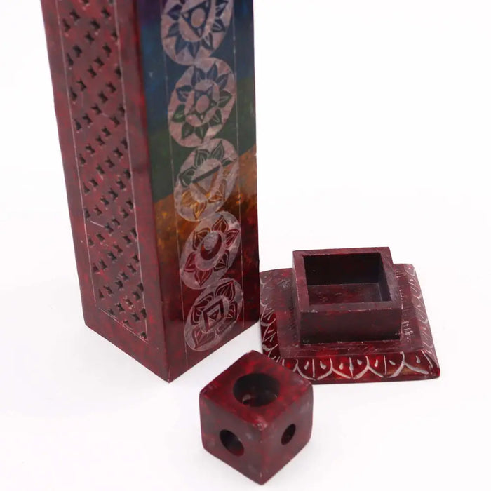 A maroon soapstone tower incense holder with chakra symbols and a matching lid for burning tower incense