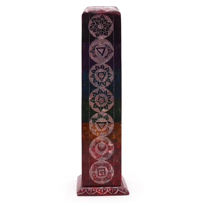 A tall rectangular multi-colored resin soapstone tower incense holder with seven chakra symbols etched on it