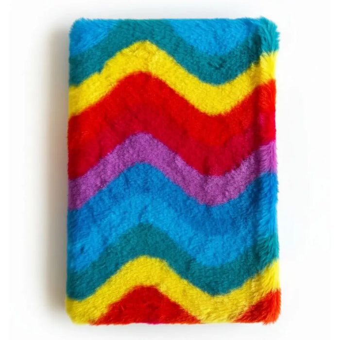 A soft book dream journal with an 80 page magic theme and a plush rainbow zigzag blanket in fuzzy material