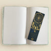 A dark blue soft book dream journal with gold dreamcatcher design and text featuring moonlight messages, 80 pages
