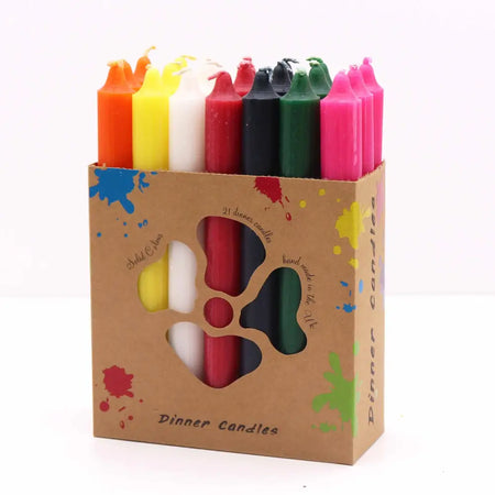 A solid colour dinner candle set with 21 assorted color candles in a brown box with paint splatter design
