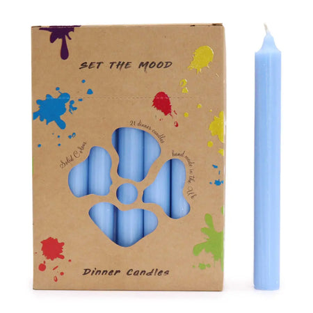 A solid colour dinner candle in rustic sea blue made of smooth wax stands beside its cardboard packaging