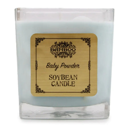 A light blue soy wax candle in a clear 5cm glass jar with an ornate bamboo label reading baby powder
