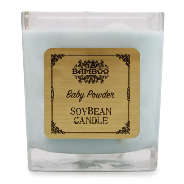 A light blue soy wax candle in a clear 5cm glass jar with an ornate bamboo label reading baby powder