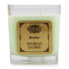 A square glass jar holds a pale green soy wax candle with a wooden label bamboo by aw bamboo measuring 5cm