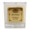 A white soy wax candle in a clear 5cm square glass jar with a gold bamboo home bakery label