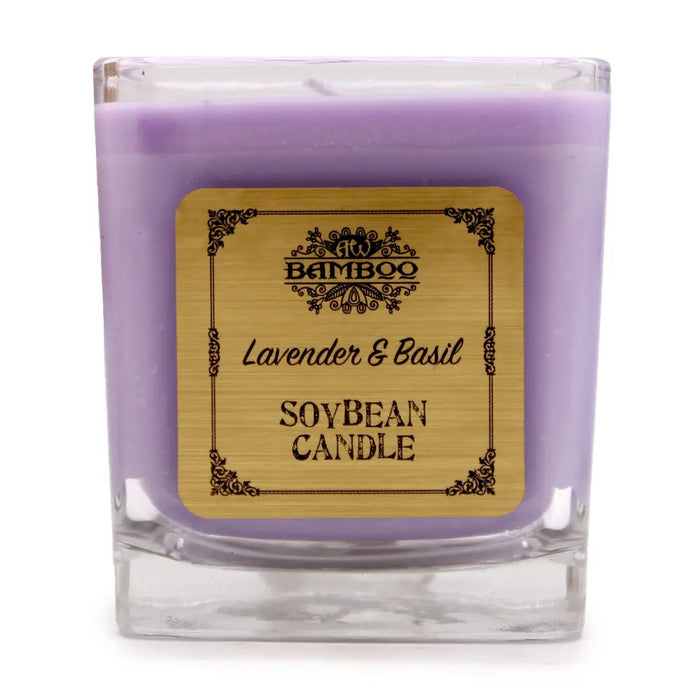 A lavender-colored soy wax candle in a clear 5cm square glass jar labeled bamboo lavender and basil