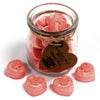 Pink heart shaped soy wax melts in a clear glass jar with rustic twine and brown paper tag labeled classic rose