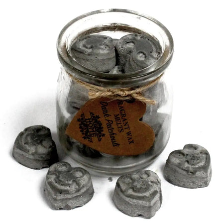 Gray heart-shaped soy wax melts in a clear glass jar with rustic twine tag labeled dark patchouli scent