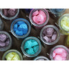 Colorful bear-shaped soy wax melts in clear glass jars labeled dark sandalwood scent