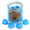 Blue heart shaped dewberry soy wax melts in a clear glass jar with a rustic brown tag