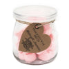 A clear glass jar of pink heart-shaped soy wax melts labeled midnight jasmine by home brand