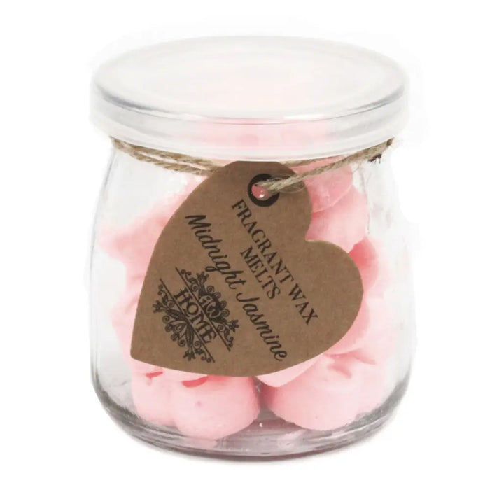 A clear glass jar of pink heart-shaped soy wax melts labeled midnight jasmine by home brand