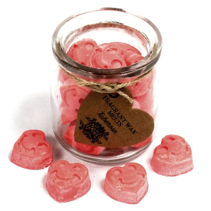 Pink heart shaped soy wax melts in a clear glass jar with a rustic brown tag scented with tuberose