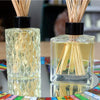 Two 200ml glass reed diffusers with textured diamond and clear bottles filled with golden liquid and black diffuser sticks