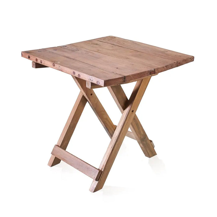 A rustic square folding coffee table made of teak wood with a natural finish and metal fasteners