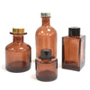 Set of four amber glass square reed diffuser bottles 100ml with gold silver and black caps for bamboo reed diffuser use