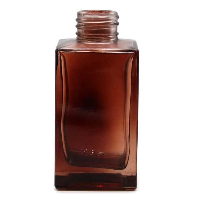 A translucent amber glass square reed diffuser bottle 100ml with a threaded neck for bamboo reed diffuser use