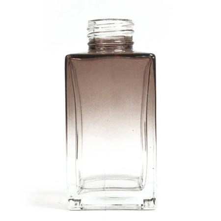 A sleek square reed diffuser bottle 100ml with a dark brown to clear gradient glass finish for bamboo reed diffuser use