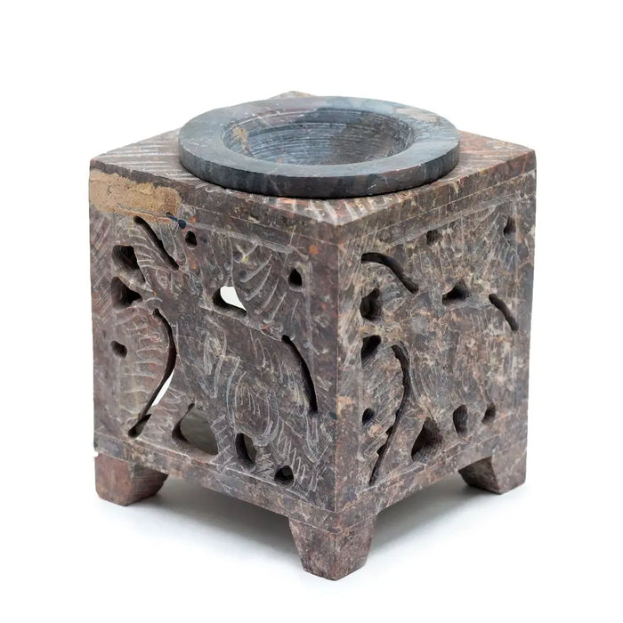 Square soapstone oil burner with brown marble body, carved patterns, and dark circular top for soapstone oil use