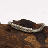 Sterling silver and 18ct yellow gold single chain bracelet with braided design and diamond pattern engraving