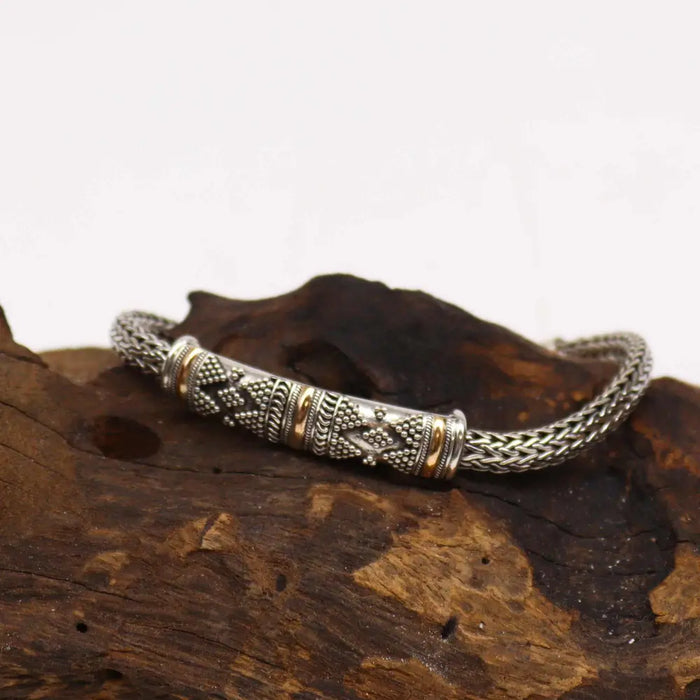 Sterling silver and 18ct yellow gold single chain bracelet with braided design and diamond pattern engraving